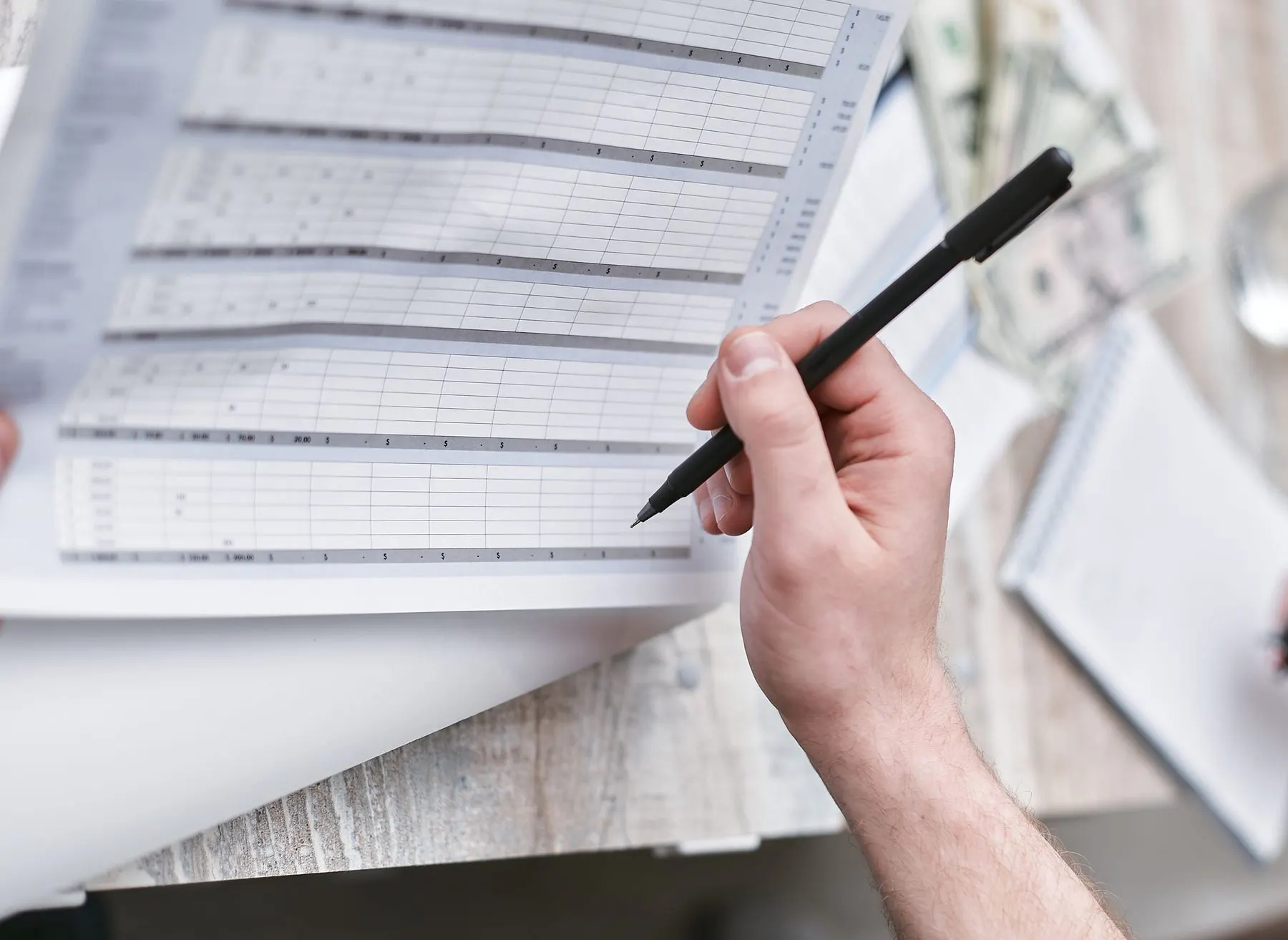 Reviewing a bookkeeping ledger by hand